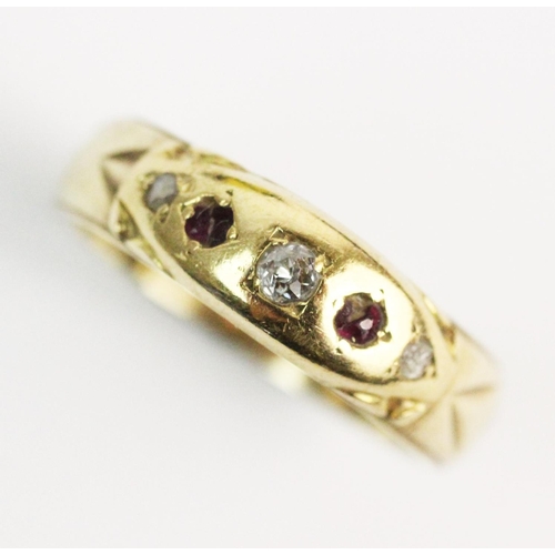 193 - A 9ct gold diamond and ruby set ring, comprising a small old cut diamond with a single cut diamond a... 