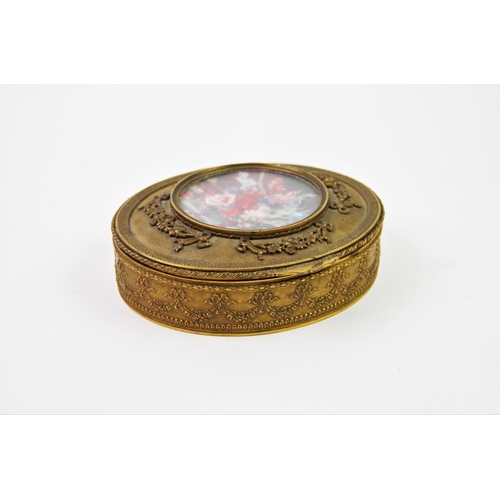 207 - A Palais Royal style French gilt metal box, 20th century,  with glazed central panel and lined inter... 