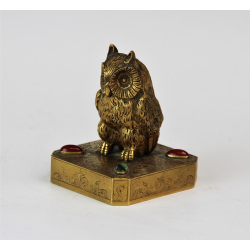 228 - An early 20th century gilt bronze owl paperweight, designed as an owl form finial, to a plaster fill... 