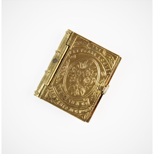 229 - A 19th century miniature gilt brass album, of rectangular form, the hinged cover decorated with flor... 