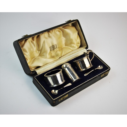 26 - A George V silver condiment set, Harrods Ltd, London 1934, comprising: a salt, a pepperette, a wet m... 