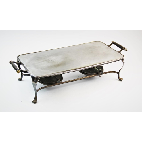 81 - A Victorian style twin handled hot plate, the steel hot plate set in a white metal stand with scroll... 