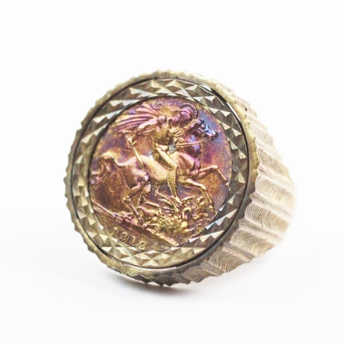 100 - A sovereign set 9ct gold dress ring, the George V sovereign dated 1912, set to a raised textured mou... 