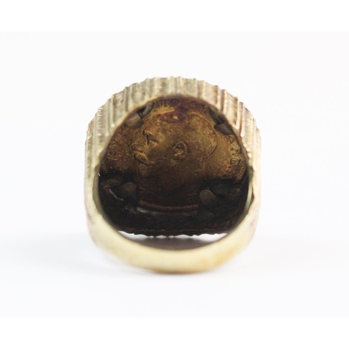 100 - A sovereign set 9ct gold dress ring, the George V sovereign dated 1912, set to a raised textured mou... 