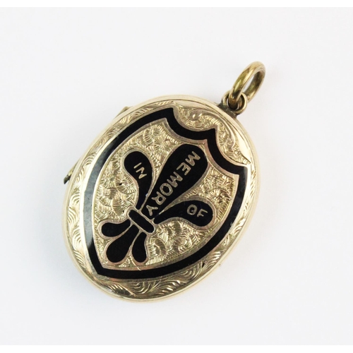 156 - A Victorian enamelled memorial locket pendant, the yellow metal oval shaped pendant with black ename... 