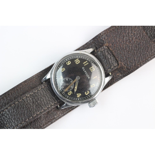 109 - A gent's Glycine military wristwatch, the round black dial with luminous Arabic numerals and hands w... 