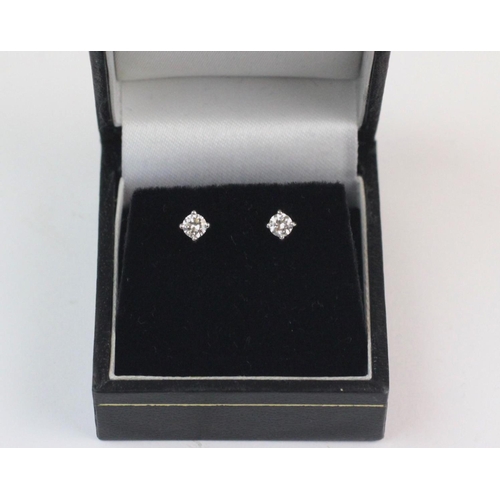 154 - A pair of diamond solitaire stud earrings, each set with a brilliant cut diamond measuring approx 0.... 