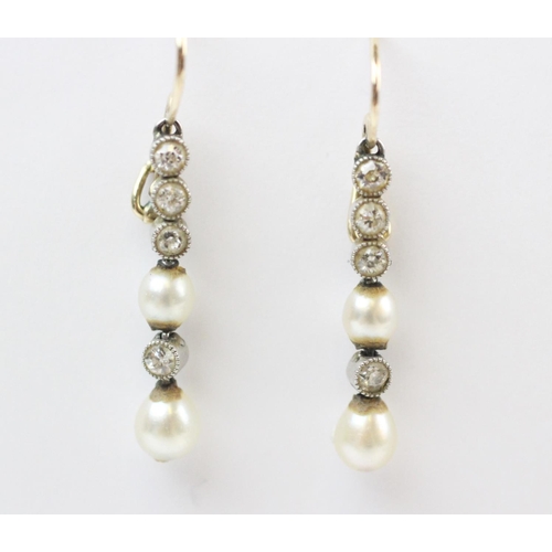 165 - A pair of early 20th century diamond and pearl drop earrings, each suspending two off-round pearls a... 