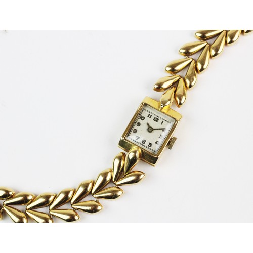 119 - A lady's 18ct gold cocktail watch, white rectangular dial with gold toned Arabic numerals, set to a ... 