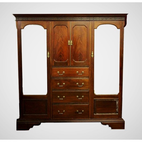 926 - A 1920's Chinese Chippendale revival mahogany compactum wardrobe, with a dentil cornice above a blin... 