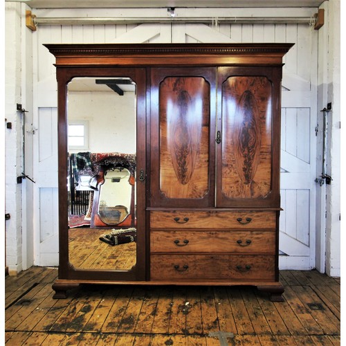 927 - An Edwardian mahogany compactum wardrobe by Garnett & Son, Chester, with a dentil cornice above a pa... 