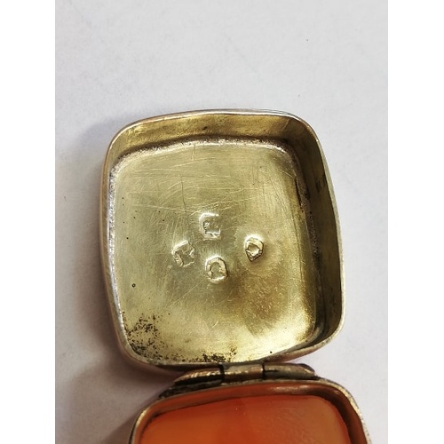 67 - A George IV gold coloured pill box, of rounded rectangular form, hinged lid set with an amber colour... 