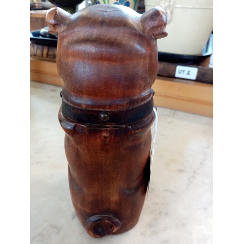 214 - A treen tobacco jar in the form of a dog, 19th century, the seated dog modelled with arms crossed to... 