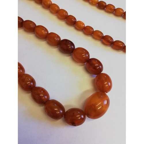 134 - A 'Butterscotch' amber single strand bead necklace, the sixty-nine graduated beads (largest measurin... 