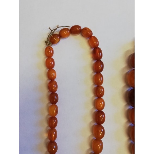 134 - A 'Butterscotch' amber single strand bead necklace, the sixty-nine graduated beads (largest measurin... 