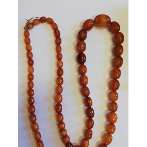 134 - A 'Butterscotch' amber single strand bead necklace, the sixty-nine graduated beads (largest measurin... 