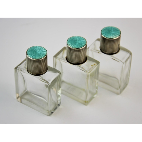 12 - A set three George V silver and enamel topped scent bottles, Goldsmiths & Silversmiths Co Ltd, Birmi... 