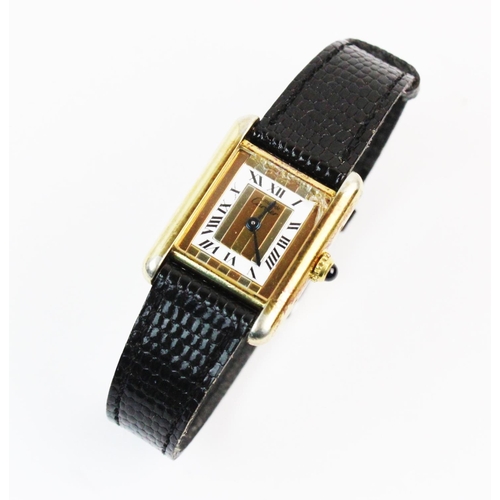 132 - A lady's silver gilt Must de Cartier Tank wristwatch, the three colour gold striped rectangular dial... 