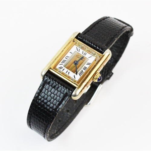 132 - A lady's silver gilt Must de Cartier Tank wristwatch, the three colour gold striped rectangular dial... 