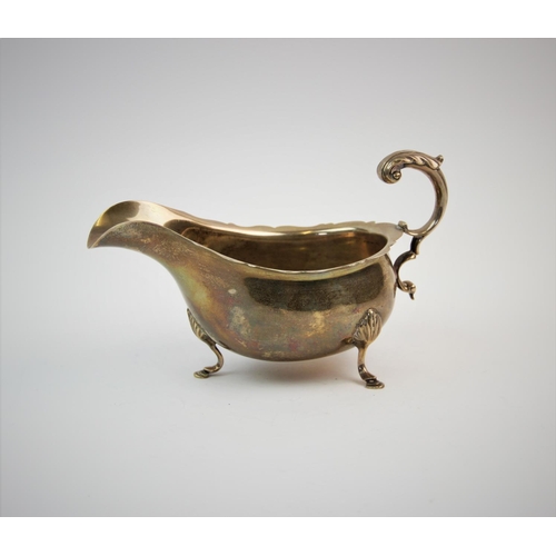 62 - A silver sauce boat, F C Richards, Birmingham 1945, of typical plain polished form, with scalloped r... 