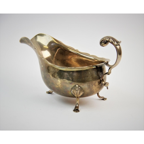 62 - A silver sauce boat, F C Richards, Birmingham 1945, of typical plain polished form, with scalloped r... 