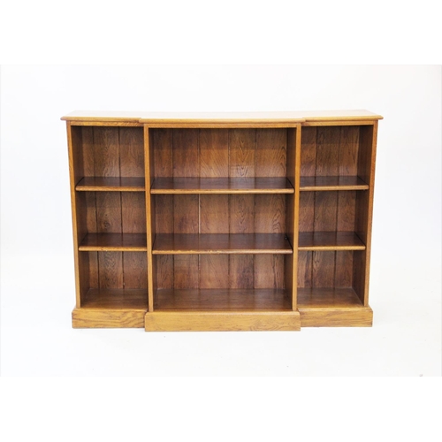 859 - A Victorian style golden oak breakfront open bookcase, late 20th century, the moulded top above an a... 