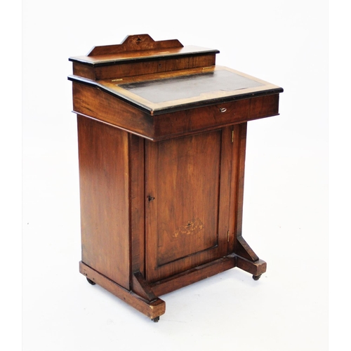 869 - A late Victorian walnut davenport, of small proportions, the inlaid hinged cover enclosing a station... 