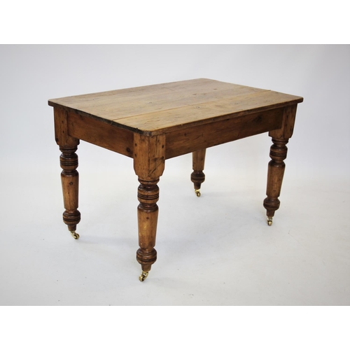 870 - A Victorian pine kitchen table, the rectangular plank top with rounded corners, raised upon turned l... 