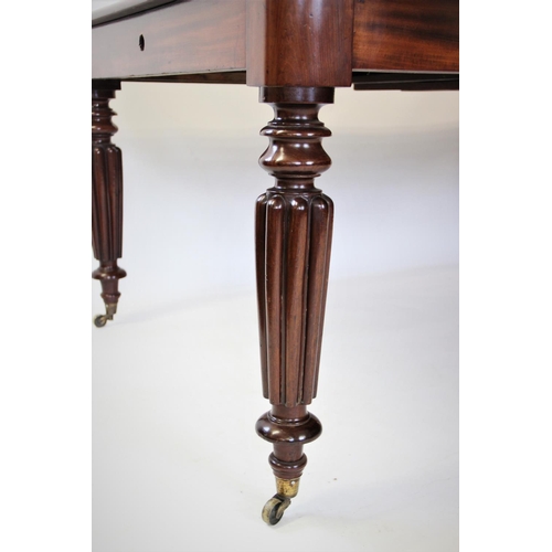 871 - A Victorian mahogany extending dining table, the rectangular moulded top with rounded corners, above... 