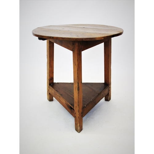 872 - A 19th century elm and pine cricket table, the circular elm top raised upon three pine angled legs w... 