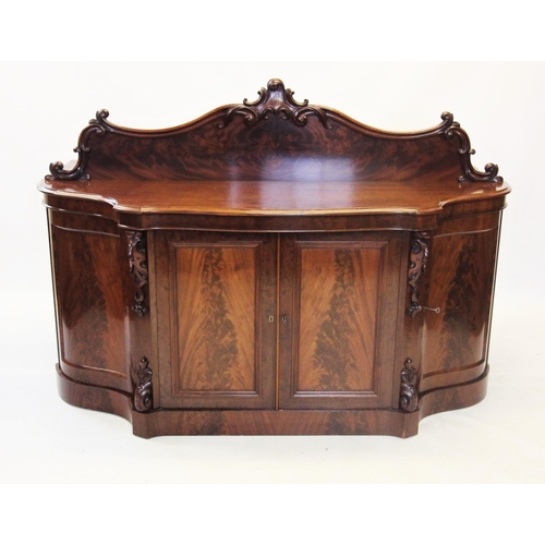 873 - A Victorian mahogany chiffonier /sideboard, the shaped raised back centred with a carved scrolling l... 