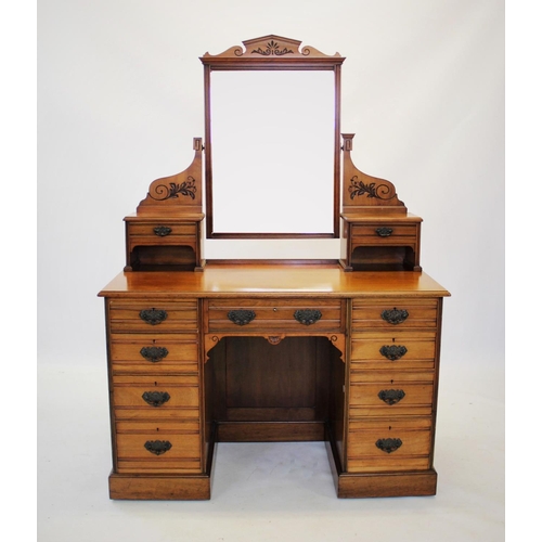 874 - A late Victorian walnut kneehole dressing table by Lamb of Manchester, the rectangular bevelled mirr... 