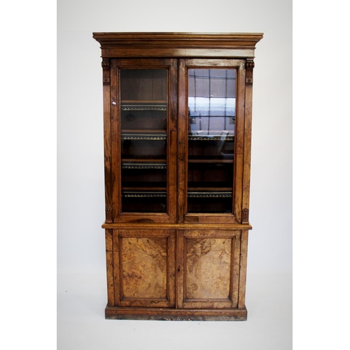 877 - A Victorian oak and pollard oak library bookcase, with a cavetto cornice above a pair of glazed door... 