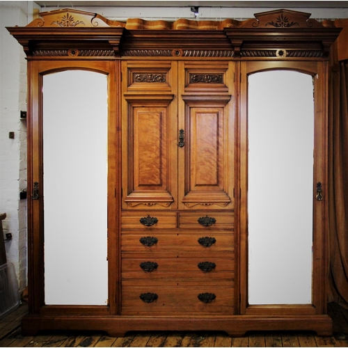 879 - A late Victorian walnut compactum wardrobe, by Lamb of Manchester, with twin architectural pediment ... 