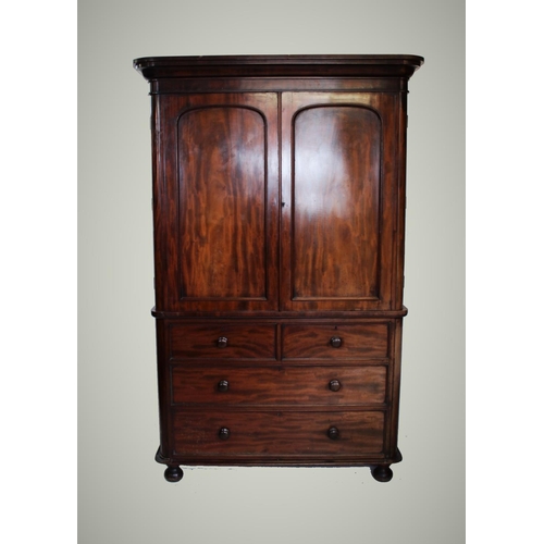 890 - A Victorian mahogany linen press, with a cavetto cornice above two panelled doors enclosing four sli... 