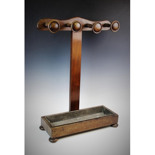 896 - A Victorian mahogany stick stand, later constructed, of 'T' form, the cupids bow top rail applied wi... 