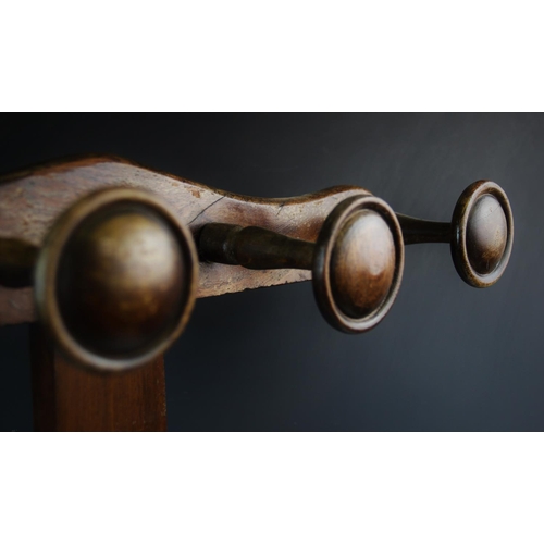 896 - A Victorian mahogany stick stand, later constructed, of 'T' form, the cupids bow top rail applied wi... 