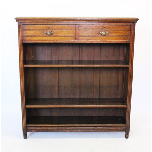 917 - An Edwardian oak open bookcase, with a rectangular moulded top above two frieze drawers and two adju... 