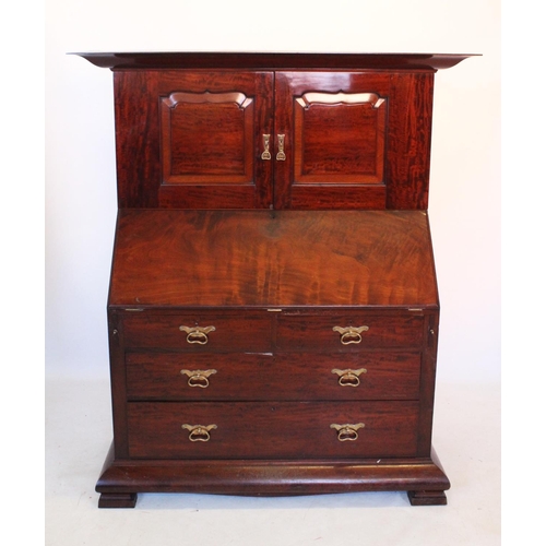 921 - A late 19th/early 20th century mahogany bureau with cupboard, by Orme and Sons, Manchester, the cupb... 