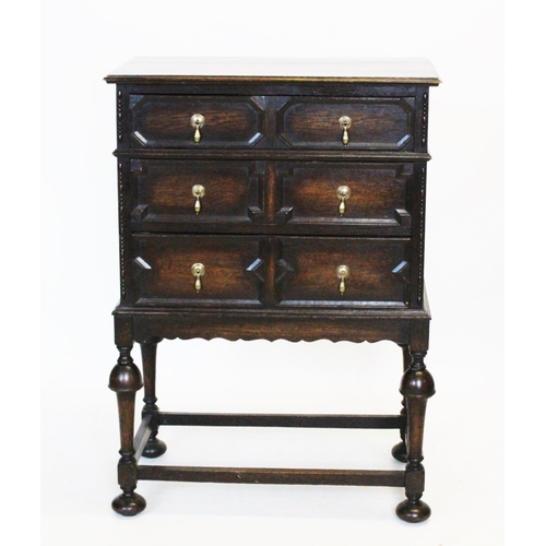 910 - A 1920's oak Jacobean revival chest on stand, with a rectangular moulded top above three graduated l... 