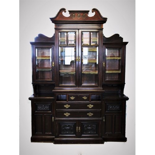 919 - An Edwardian mahogany breakfront display cabinet, with a twin swan neck pediment above a pair of bev... 