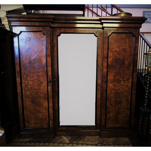 881 - A Victorian burr walnut inverted breakfront triple wardrobe, with a stepped cornice above a central ... 