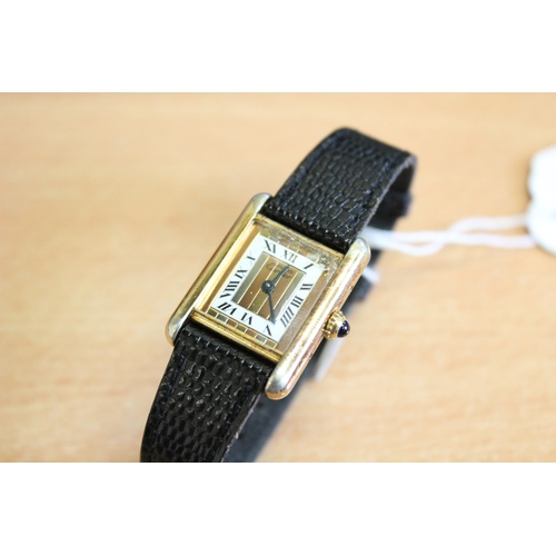 132 - A lady's silver gilt Must de Cartier Tank wristwatch, the three colour gold striped rectangular dial... 