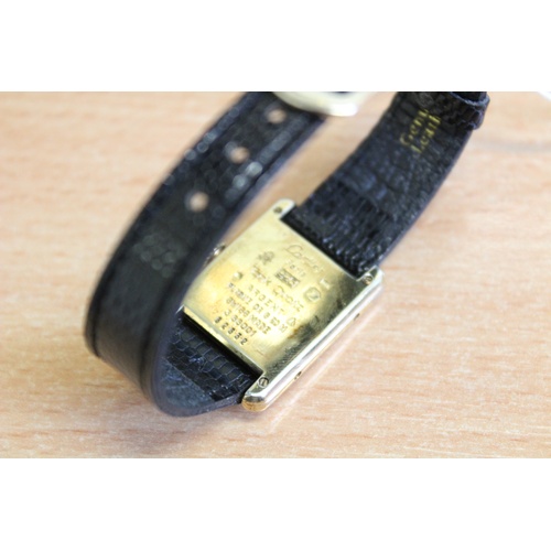 132 - A lady's silver gilt Must de Cartier Tank wristwatch, the three colour gold striped rectangular dial... 