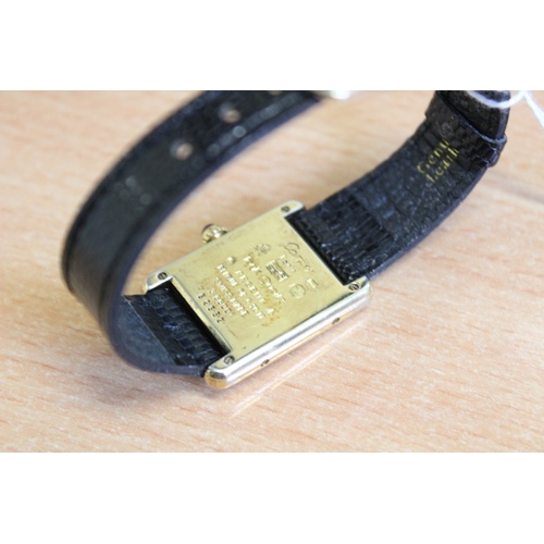 132 - A lady's silver gilt Must de Cartier Tank wristwatch, the three colour gold striped rectangular dial... 