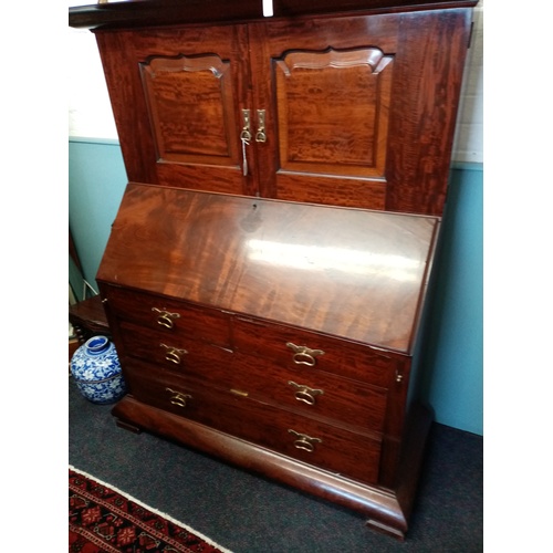 921 - A late 19th/early 20th century mahogany bureau with cupboard, by Orme and Sons, Manchester, the cupb... 