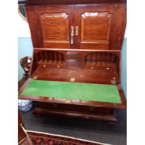 921 - A late 19th/early 20th century mahogany bureau with cupboard, by Orme and Sons, Manchester, the cupb... 