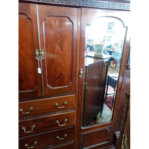 909 - A 1920's Chinese Chippendale revival mahogany compactum wardrobe, with a dentil cornice above a blin... 