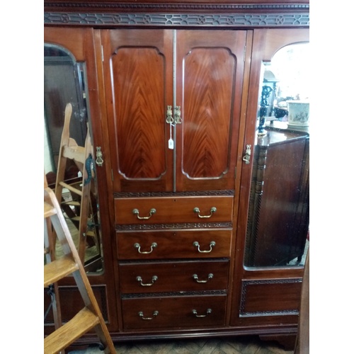 909 - A 1920's Chinese Chippendale revival mahogany compactum wardrobe, with a dentil cornice above a blin... 