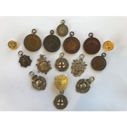 20 - A collection of early 20th century silver and assorted sporting medals, to include examples for the ... 